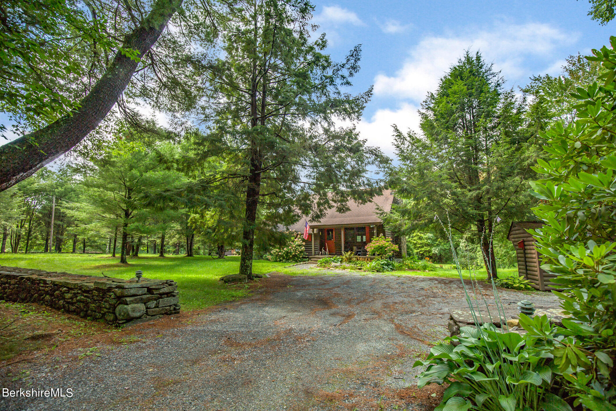 43 Becket Road Otis, MA 01029 - Photo 40 of 41 a front view of a house with a yard and trees