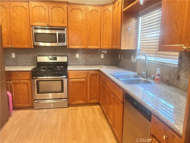 a view of a hallway with wooden floor and a fireplace