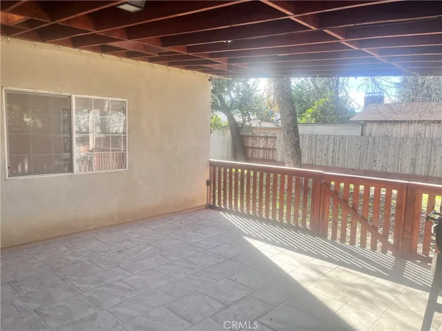 a wooden bench sitting in front of a window