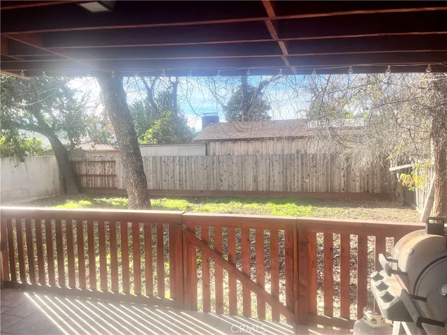 a view of garden with wooden fence