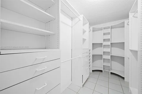 a bathroom with granite countertop a sink and a white cabinets