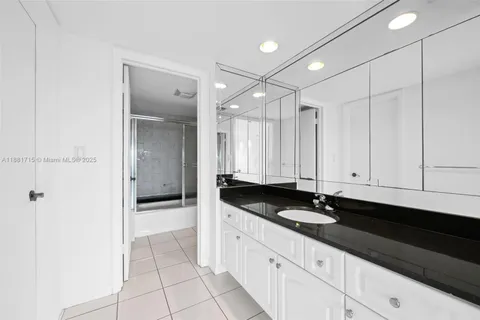 a bathroom with a glass shower door