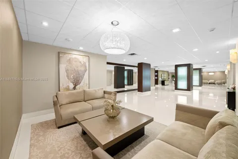 a lobby with furniture and a potted plant