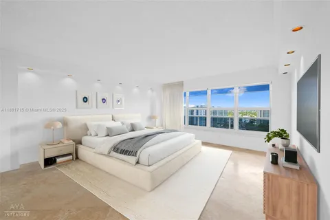 a large white bed in a white room