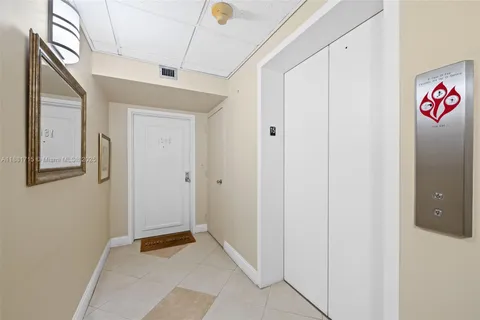 a kitchen with granite countertop a sink and white cabinets