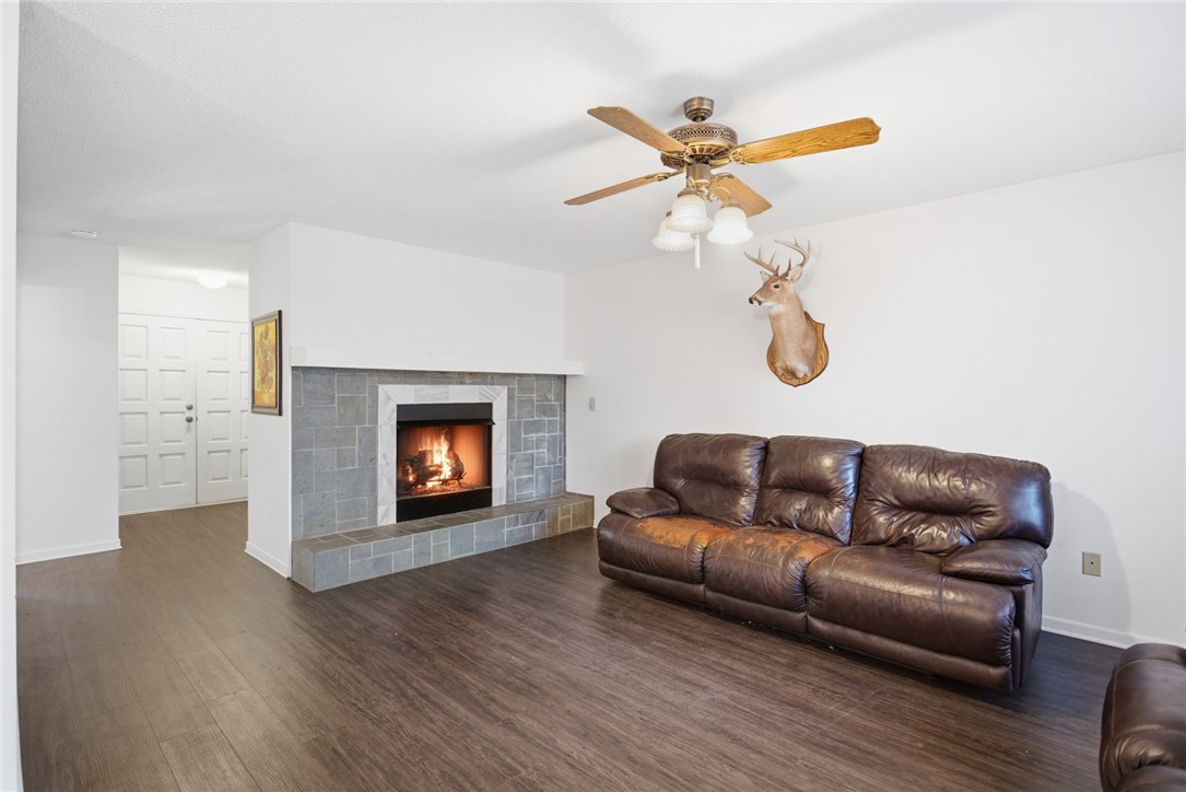 308 Wildwood Road Walhalla, SC 29691 - Photo 3 of 23 This inviting living space features a cozy fireplace and durable flooring, perfect for comfortable gatherings.