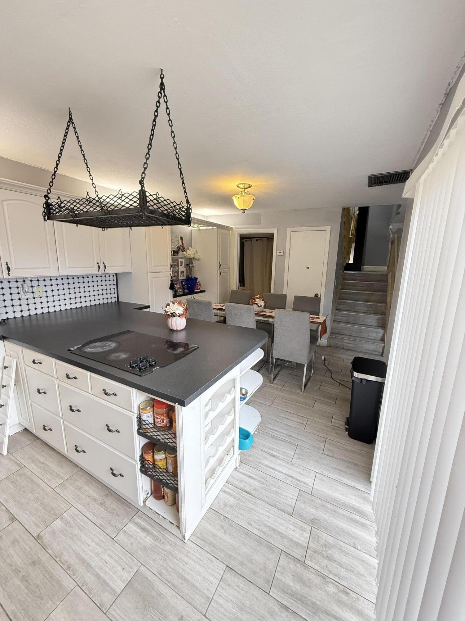 711 Springdale Circle Palm Springs, FL 33461 - Photo 2 of 11 a kitchen with stainless steel appliances granite countertop a stove a sink and a refrigerator
