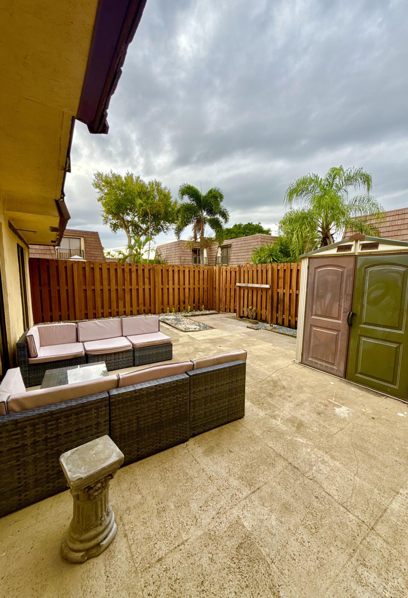 711 Springdale Circle Palm Springs, FL 33461 - Photo 5 of 11 a view of swimming pool with couches and wooden fence