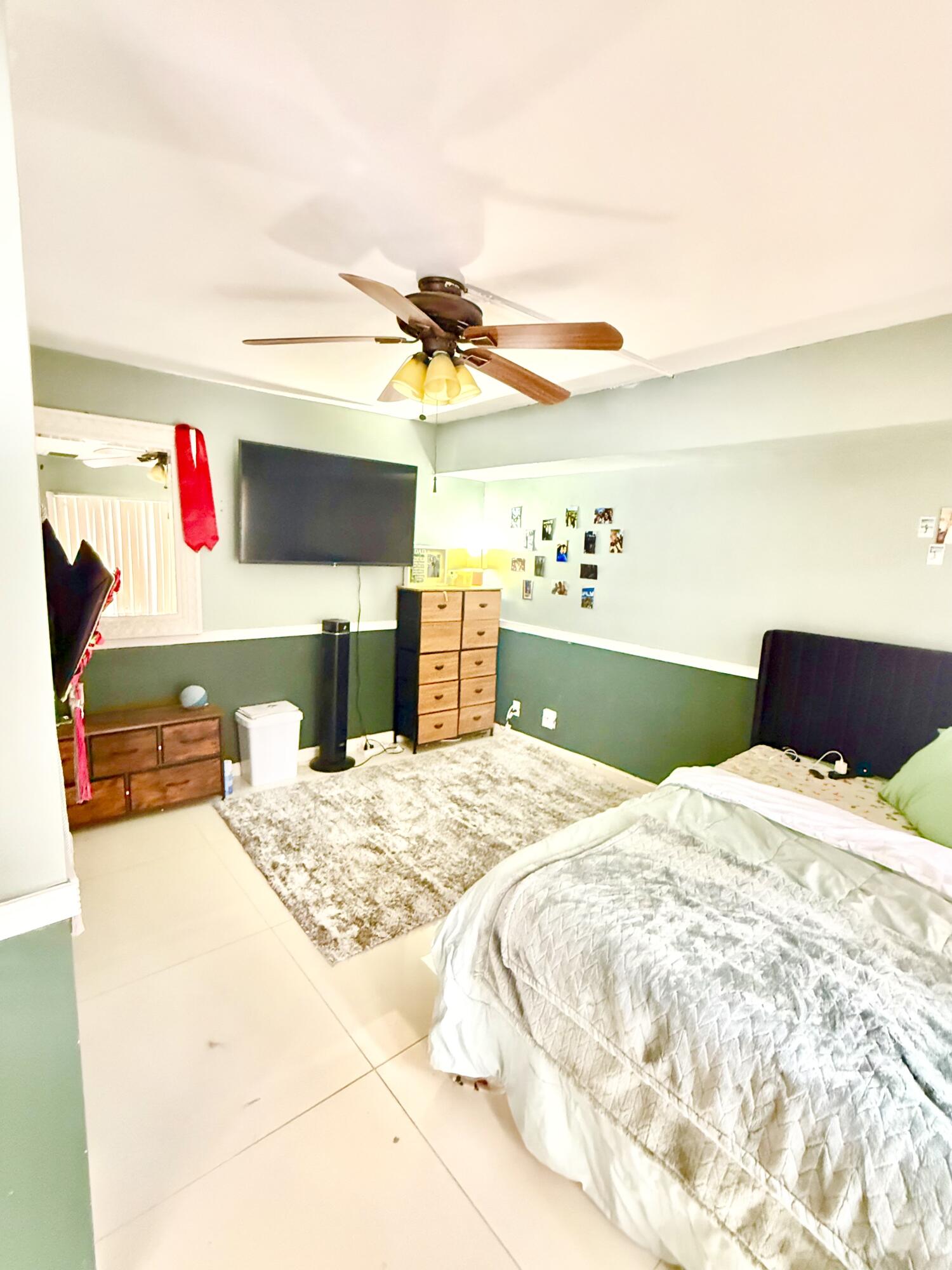 711 Springdale Circle Palm Springs, FL 33461 - Photo 8 of 11 a bedroom with a bed and a dresser