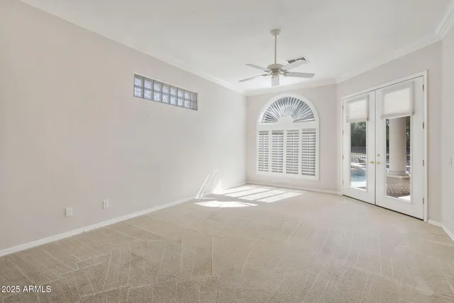 a view of an empty room with a fireplace and a window