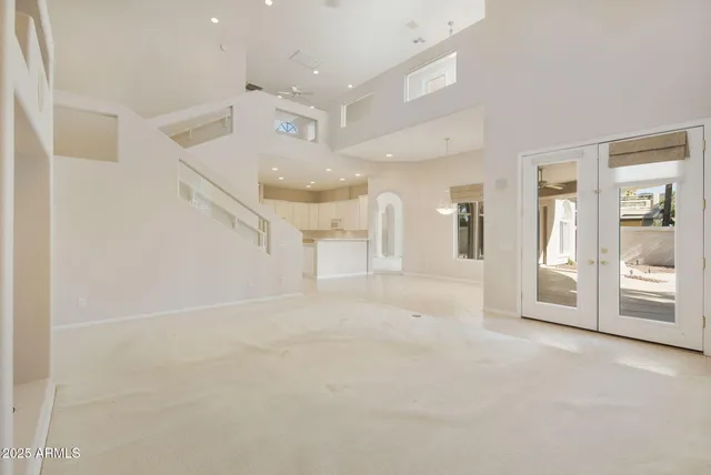 a spacious bathroom with a granite countertop tub and a large window