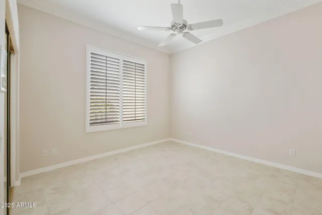 a view of an empty room with a ceiling fan