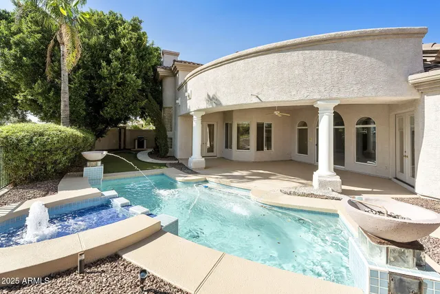 a living room with furniture chandelier and a dining table with wooden floor