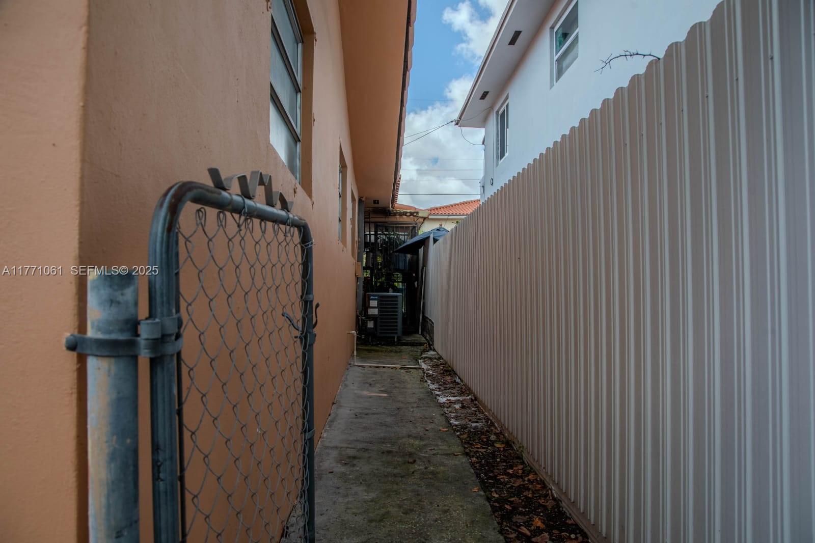 791 Northwest 22nd Place Miami, FL 33125 - Photo 14 of 33 a view of a hallway with wooden walls and stairs