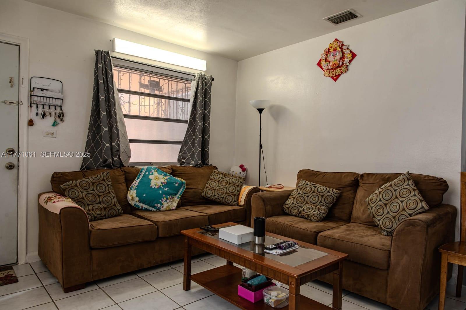 791 Northwest 22nd Place Miami, FL 33125 - Photo 18 of 33 a living room with furniture and a window