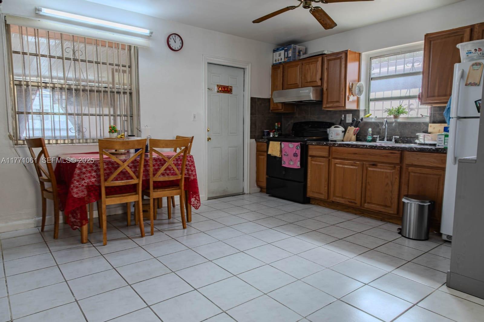 791 Northwest 22nd Place Miami, FL 33125 - Photo 20 of 33 a kitchen with stainless steel appliances granite countertop a stove a sink and a refrigerator