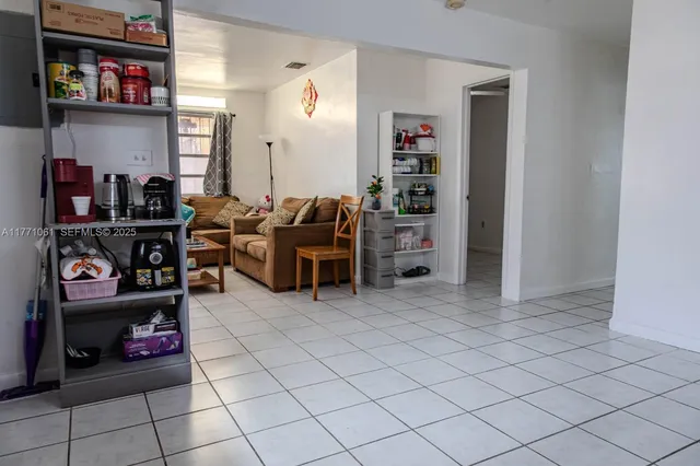 a living room with furniture and a book shelf