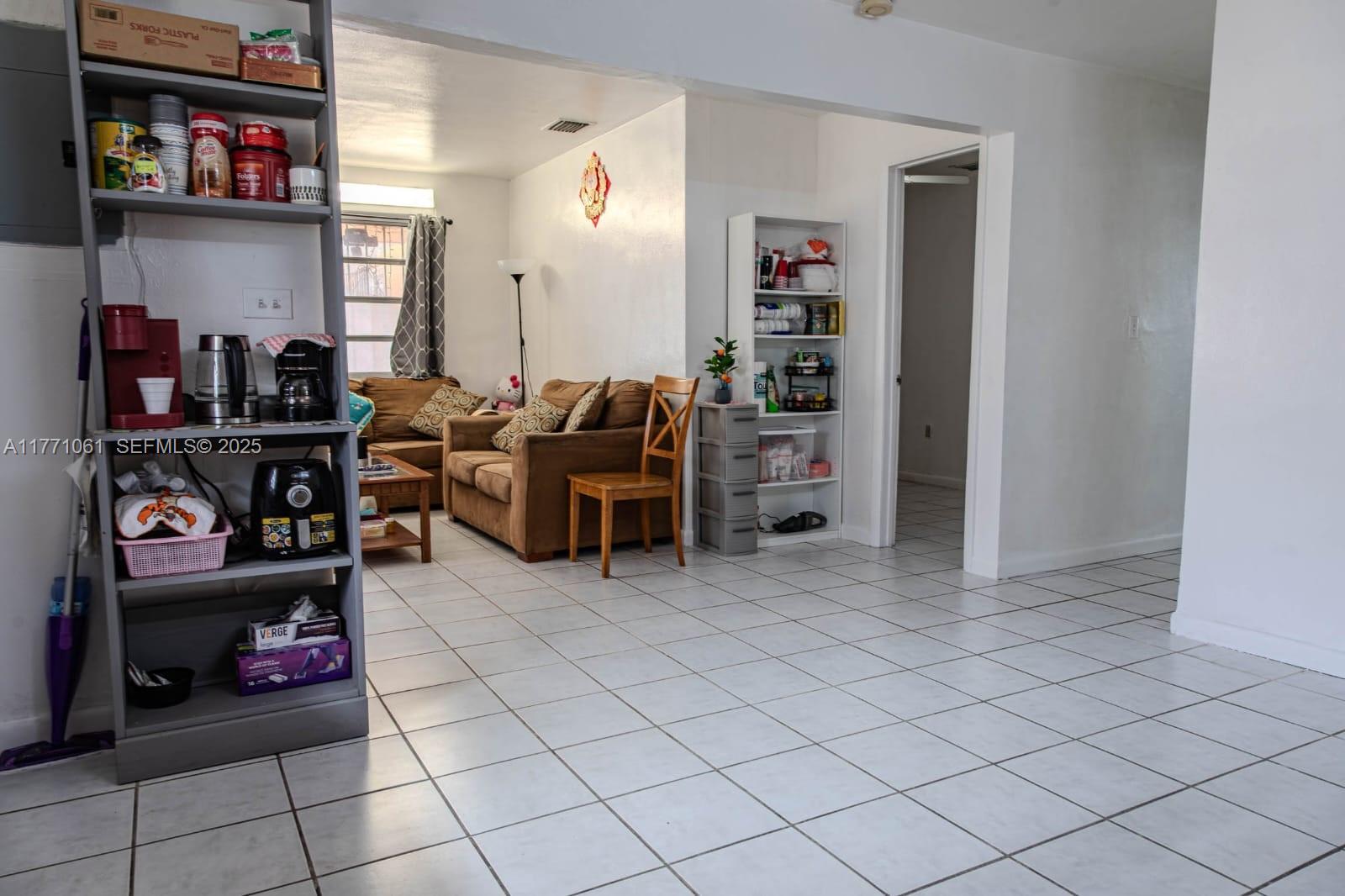 791 Northwest 22nd Place Miami, FL 33125 - Photo 21 of 33 a living room with furniture and a book shelf