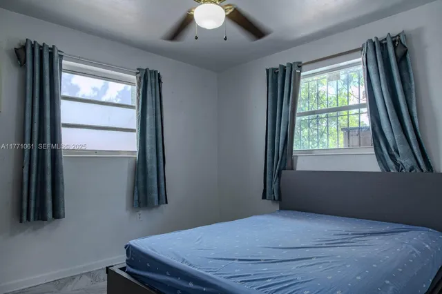 a bedroom with a bed and a window