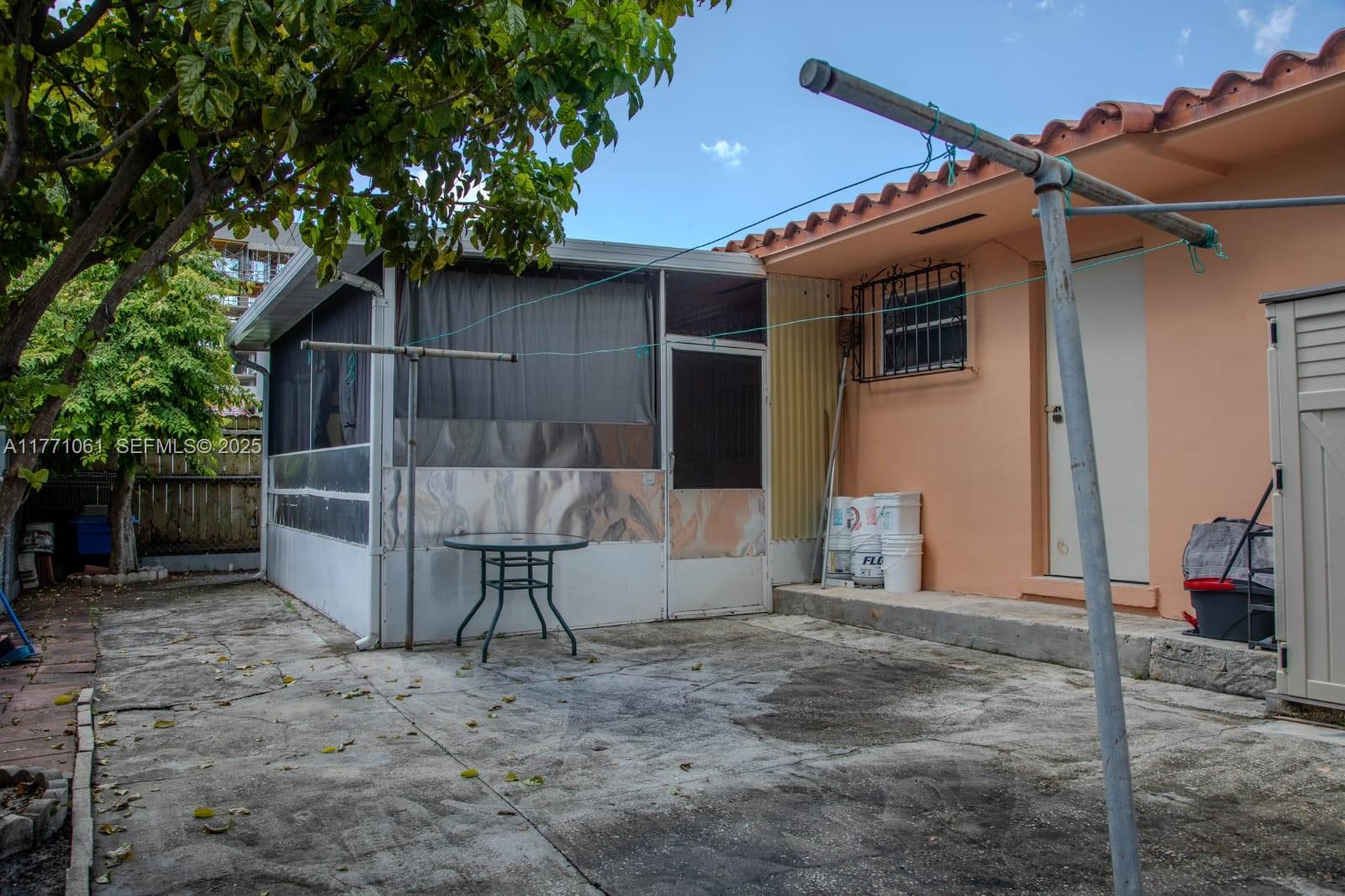 791 Northwest 22nd Place Miami, FL 33125 - Photo 9 of 33 a view of wooden house with a large tree and wooden fence