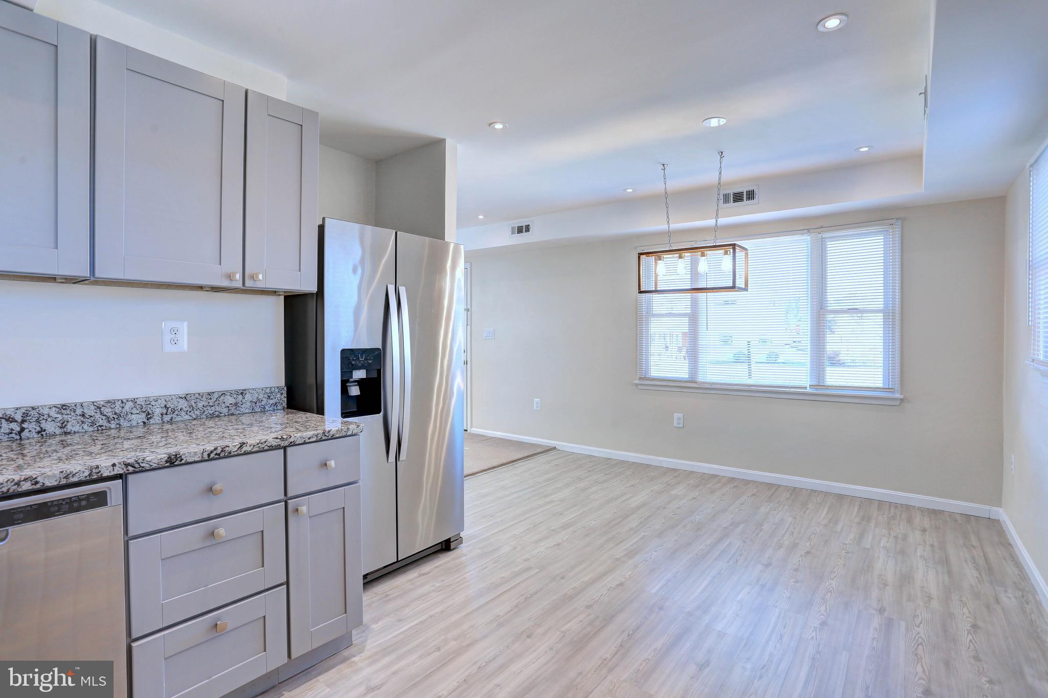 1222 Locust Avenue Halethorpe, MD 21227 - Photo 11 of 34 a kitchen with stainless steel appliances granite countertop a refrigerator sink and cabinets