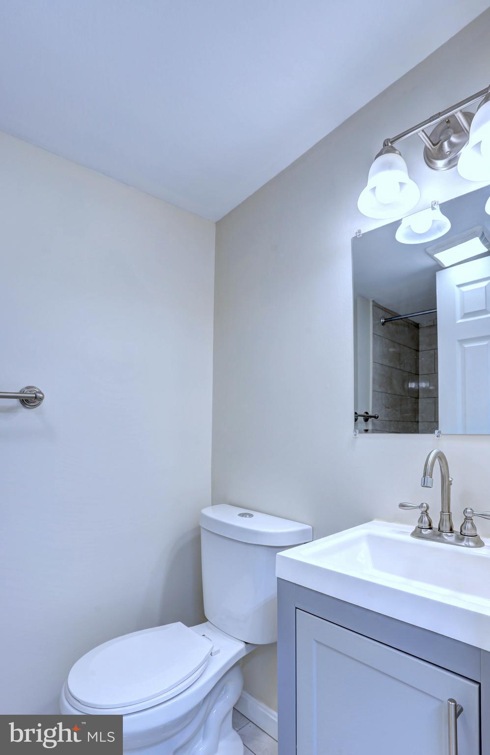 1222 Locust Avenue Halethorpe, MD 21227 - Photo 14 of 34 a bathroom with a sink a toilet and mirror