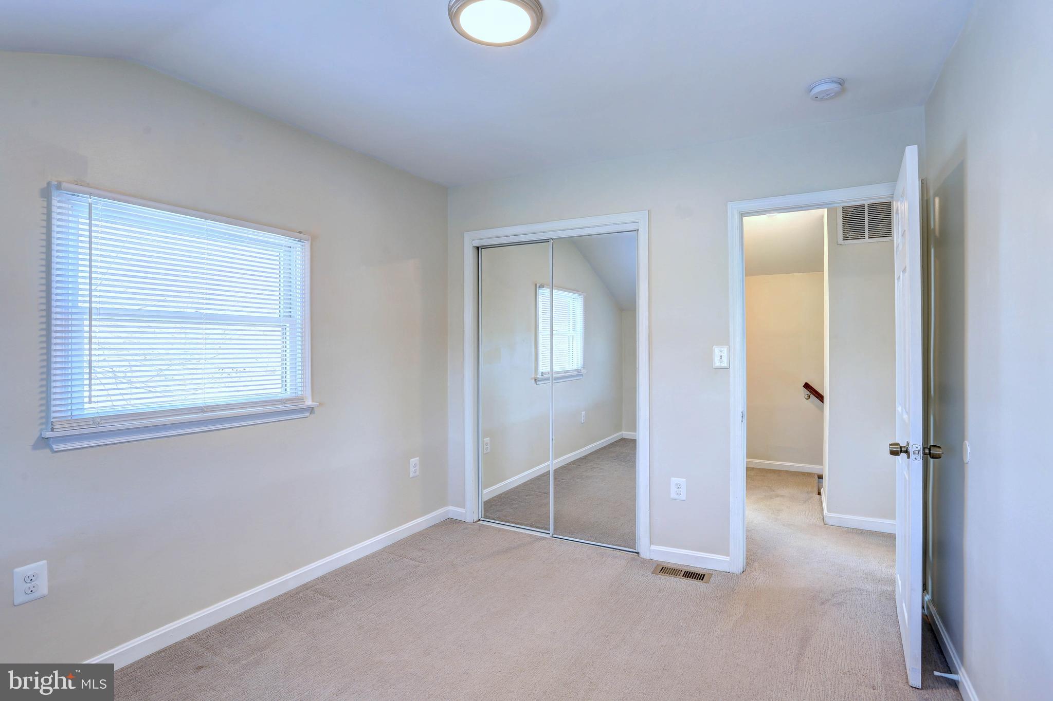 1222 Locust Avenue Halethorpe, MD 21227 - Photo 17 of 34 an empty room with windows and closet