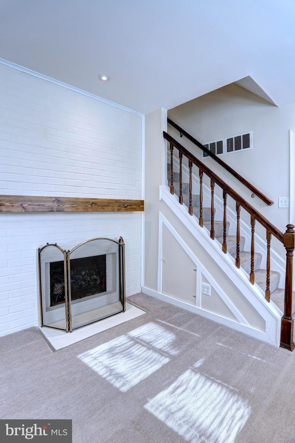 1222 Locust Avenue Halethorpe, MD 21227 - Photo 7 of 34 a view of an empty room with a fireplace and a window
