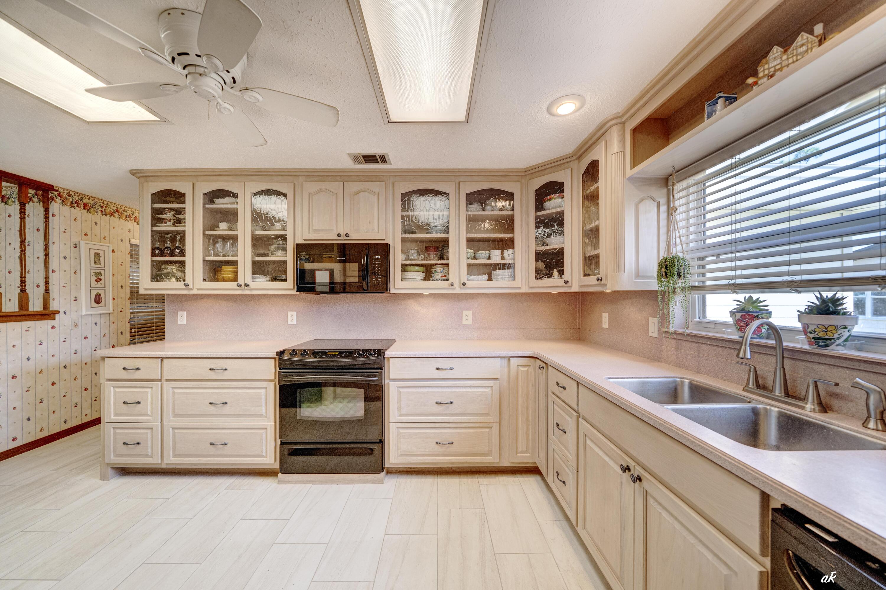 2910 Kings Harbour Road Panama City, FL 32405 - Photo 11 of 50 a kitchen with a stove cabinets and window