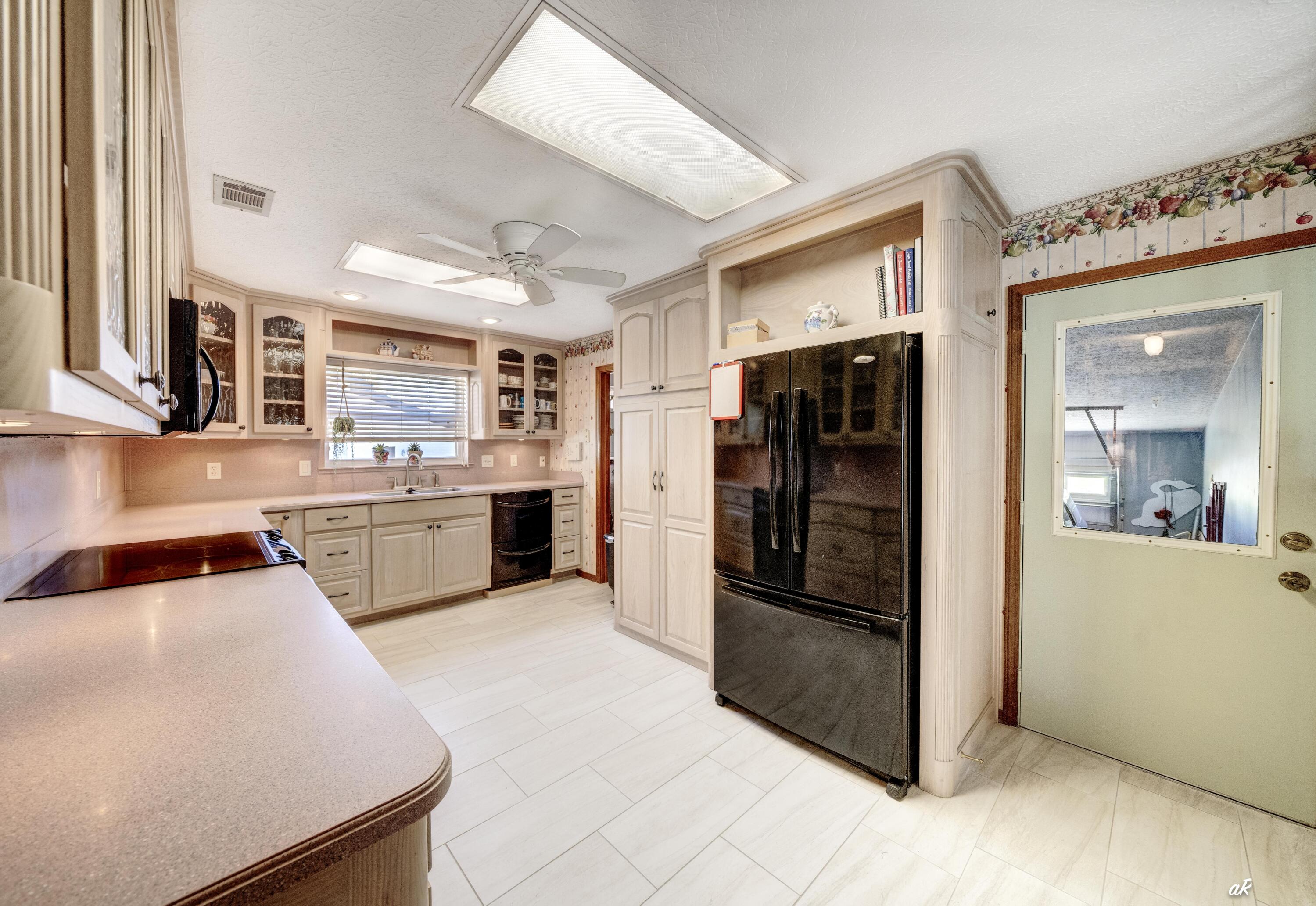 2910 Kings Harbour Road Panama City, FL 32405 - Photo 12 of 50 a kitchen with stainless steel appliances a refrigerator and a sink