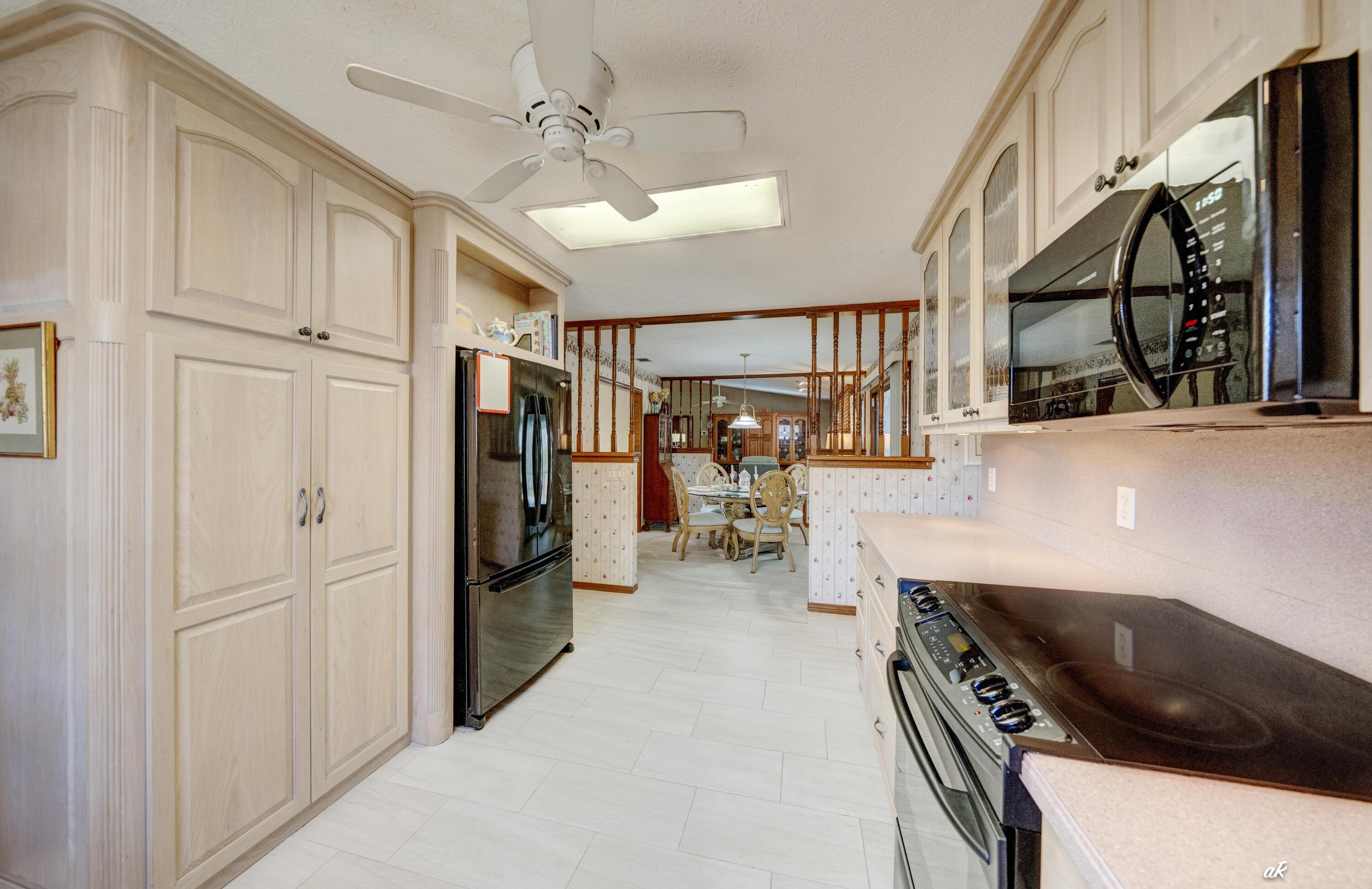 2910 Kings Harbour Road Panama City, FL 32405 - Photo 14 of 50 a kitchen with a refrigerator and a sink