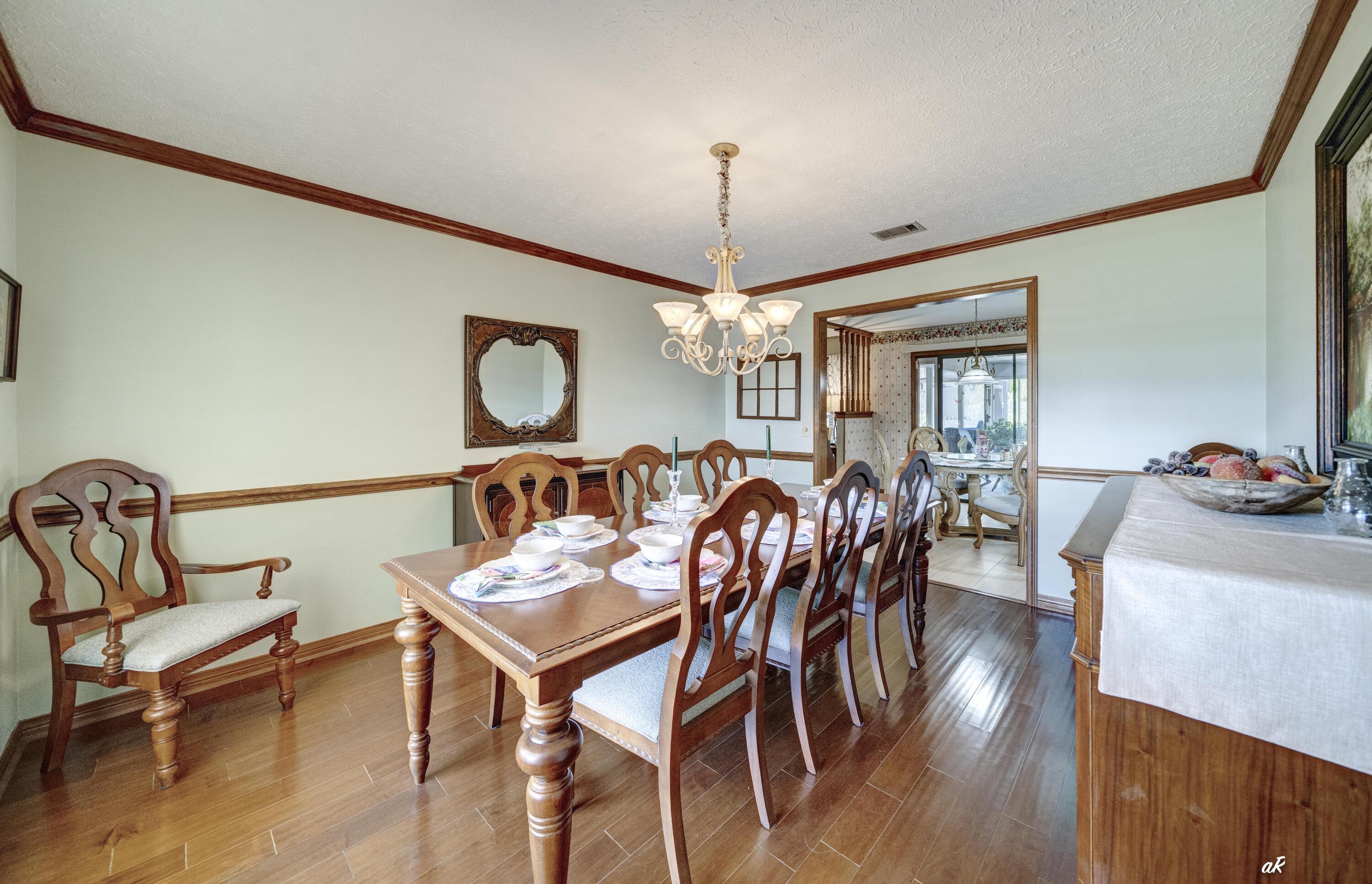 2910 Kings Harbour Road Panama City, FL 32405 - Photo 16 of 50 a view of a a dining room with furniture window and wooden floor