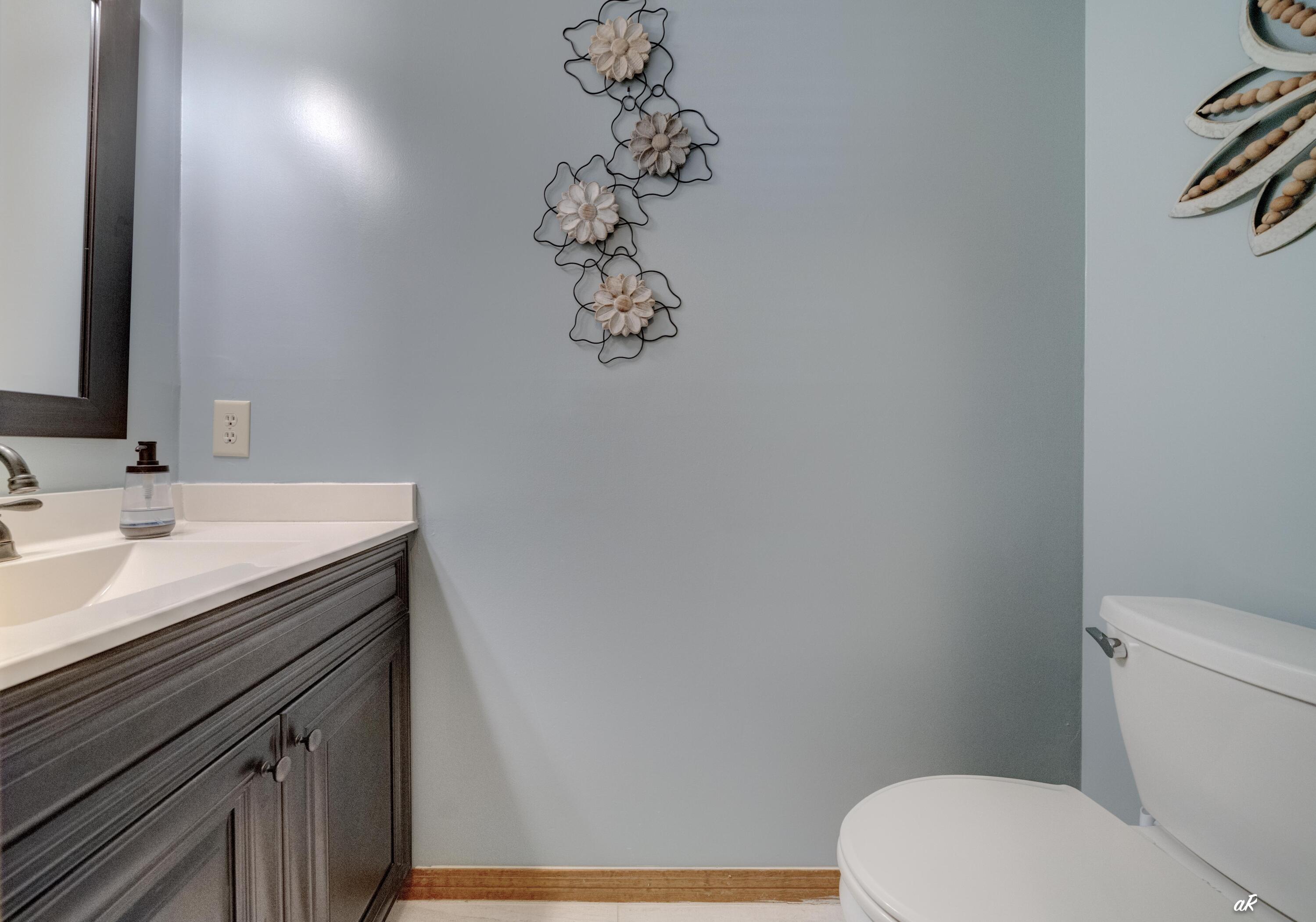 2910 Kings Harbour Road Panama City, FL 32405 - Photo 17 of 50 a bathroom with a granite countertop toilet sink and mirror