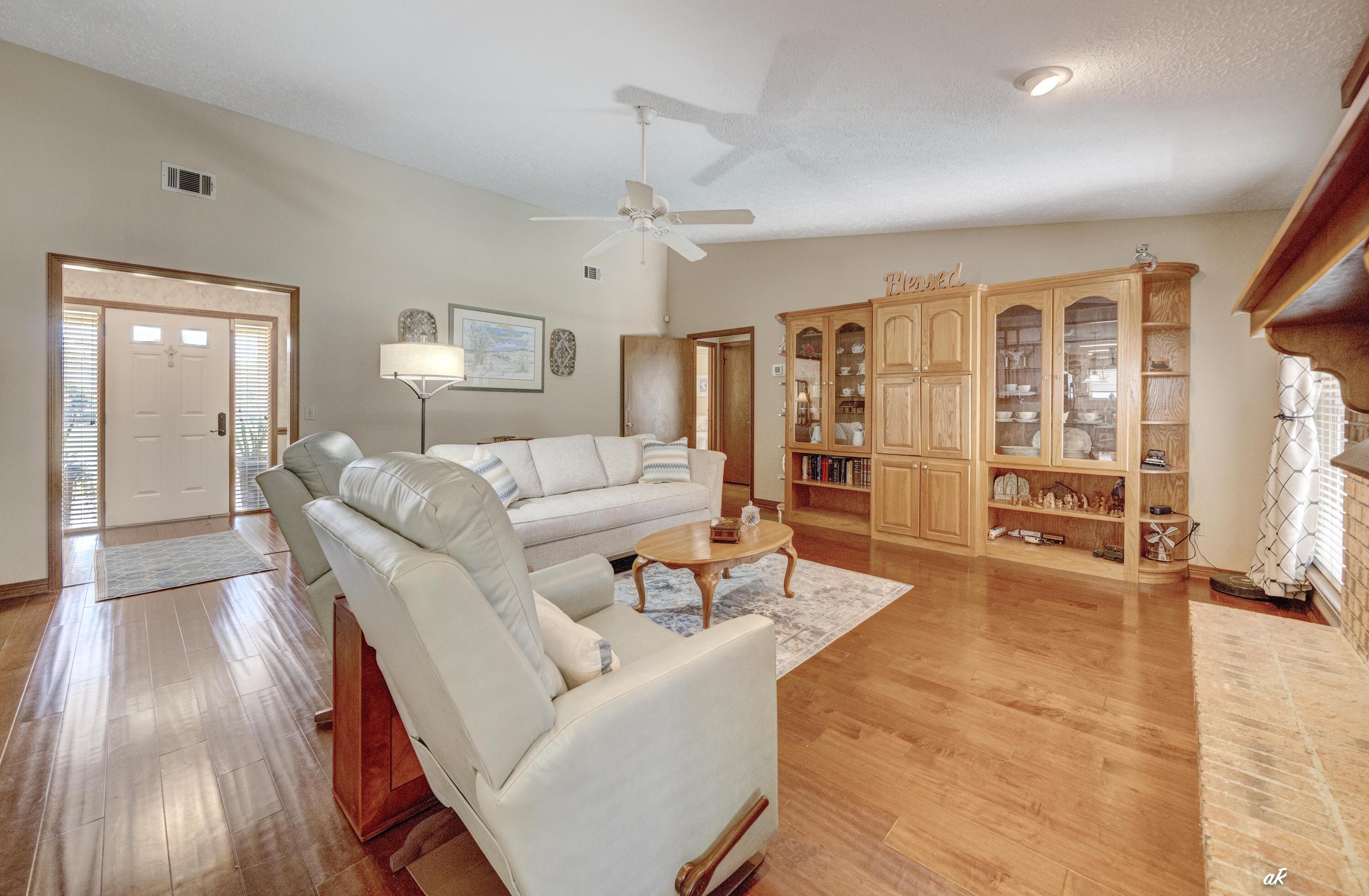 2910 Kings Harbour Road Panama City, FL 32405 - Photo 18 of 50 a living room with furniture and wooden floor