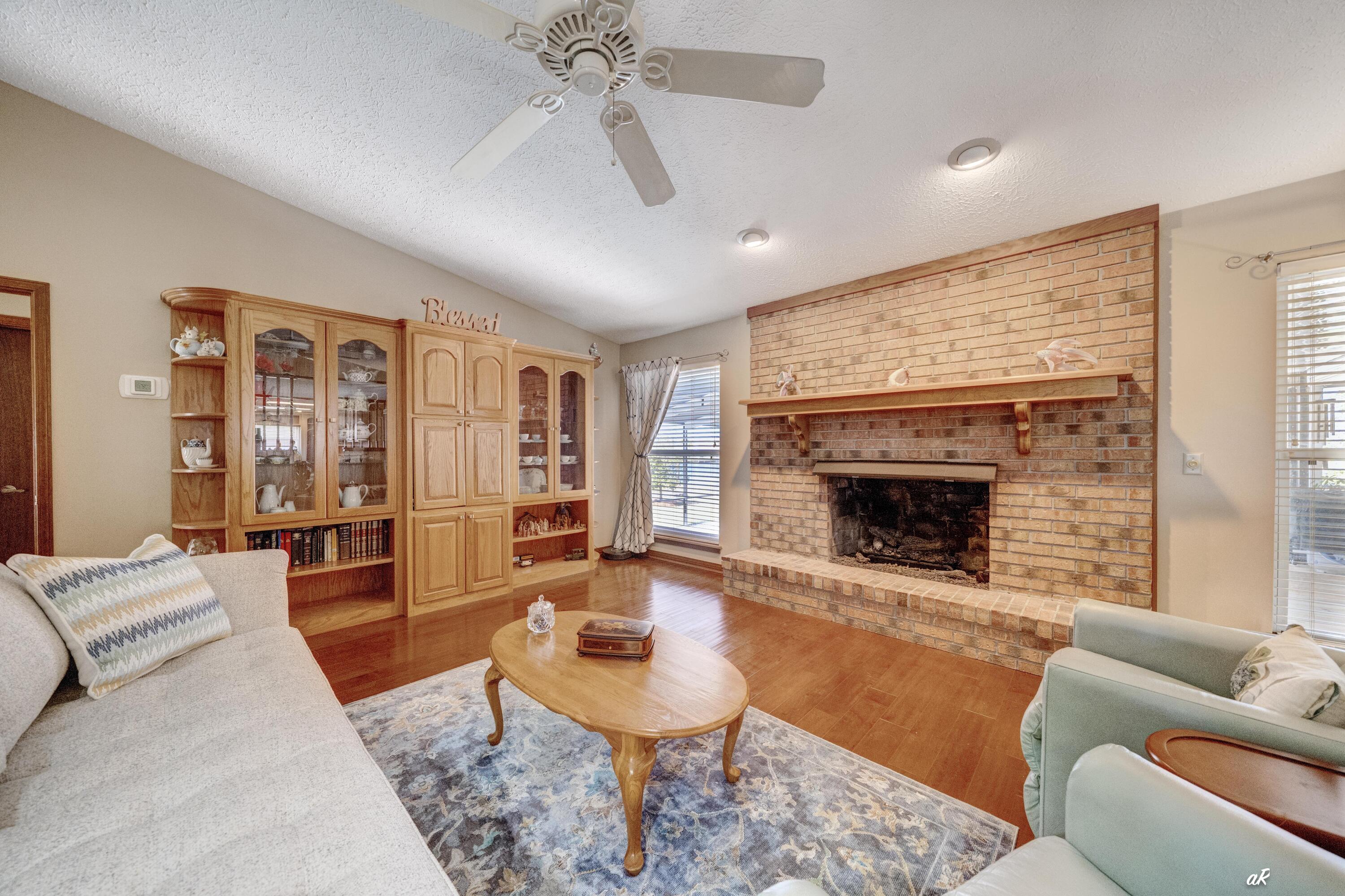 2910 Kings Harbour Road Panama City, FL 32405 - Photo 19 of 50 a living room with furniture a fireplace and a large window