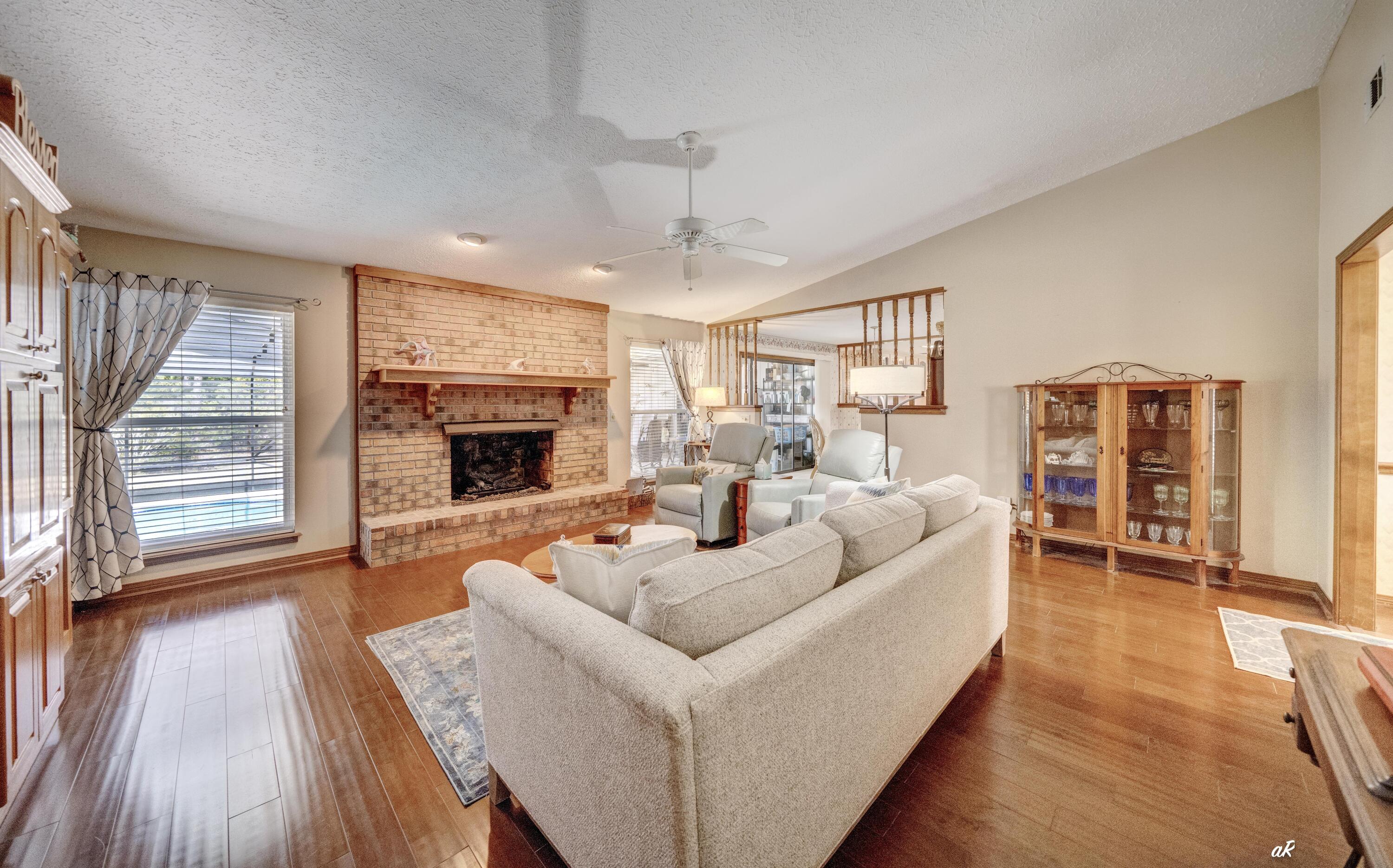 2910 Kings Harbour Road Panama City, FL 32405 - Photo 20 of 50 a living room with furniture a fireplace and wooden floor