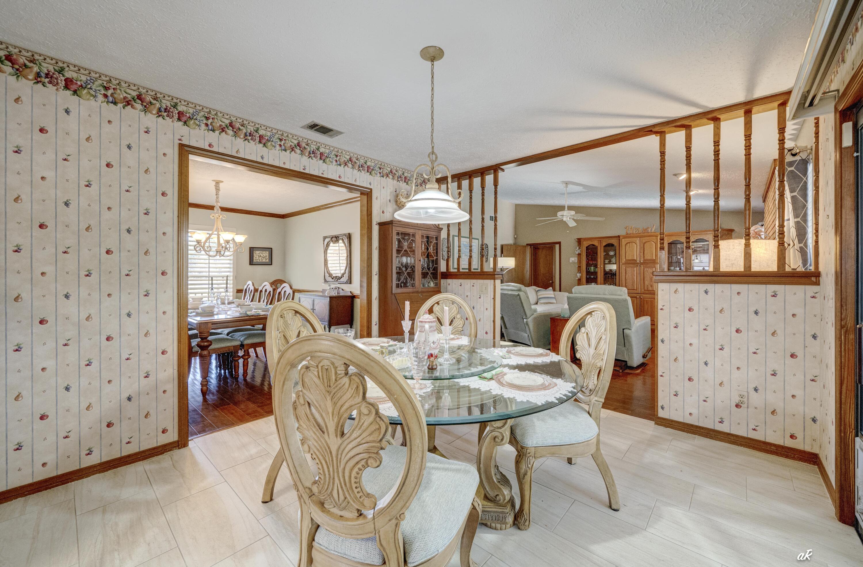 2910 Kings Harbour Road Panama City, FL 32405 - Photo 22 of 50 a dining room with furniture a chandelier and window