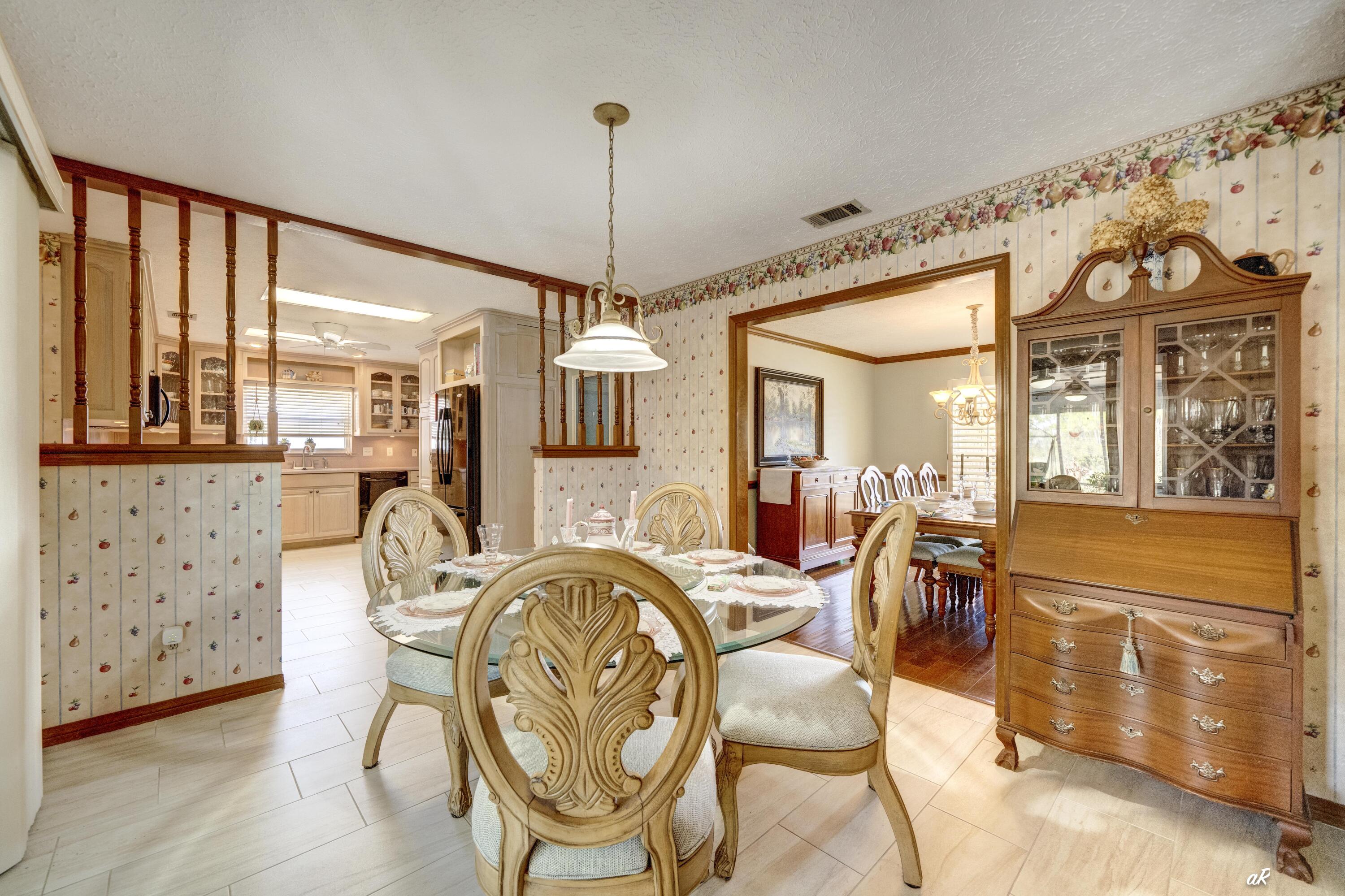 2910 Kings Harbour Road Panama City, FL 32405 - Photo 23 of 50 a view of a dining room with furniture window and wooden floor