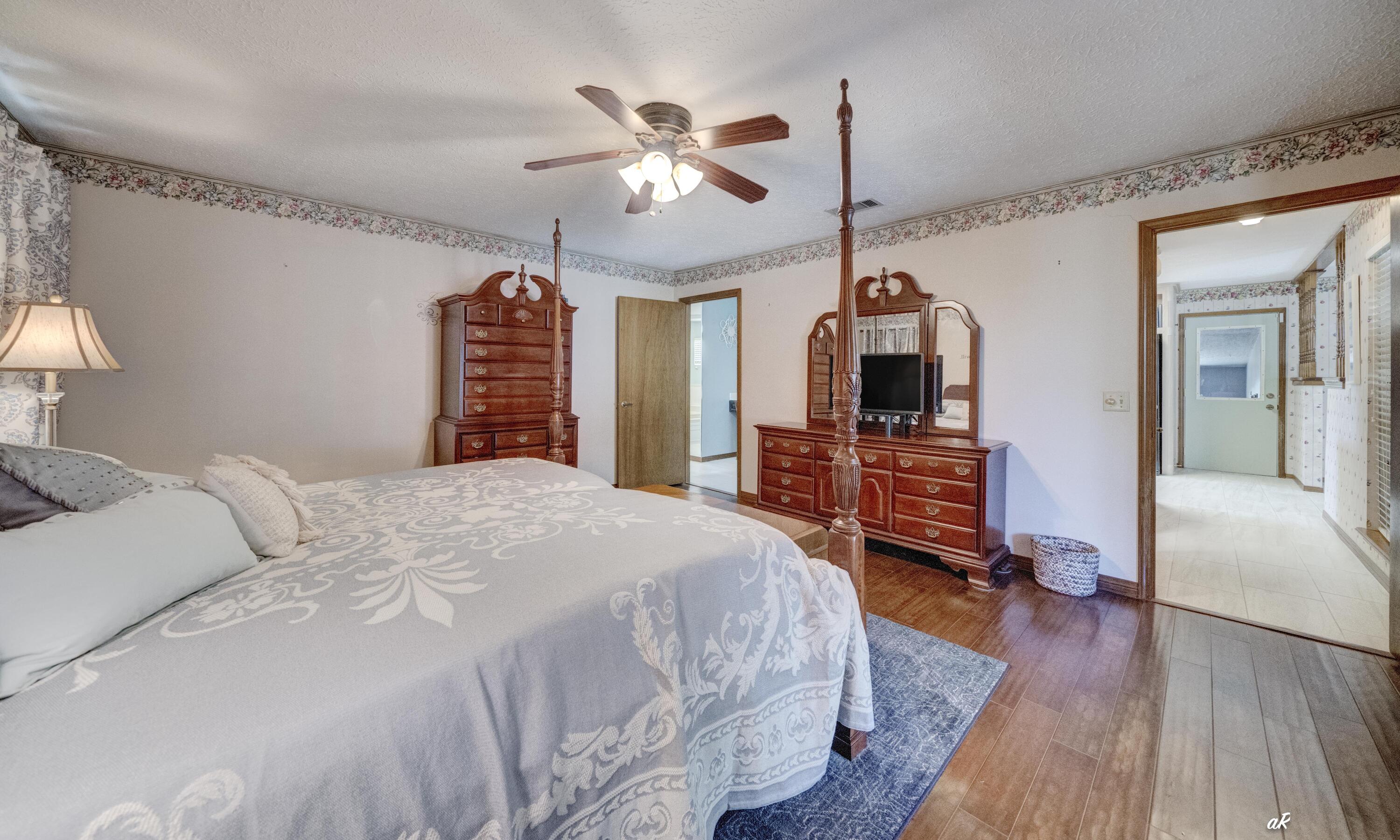 2910 Kings Harbour Road Panama City, FL 32405 - Photo 25 of 50 a bedroom with a bed and a chandelier