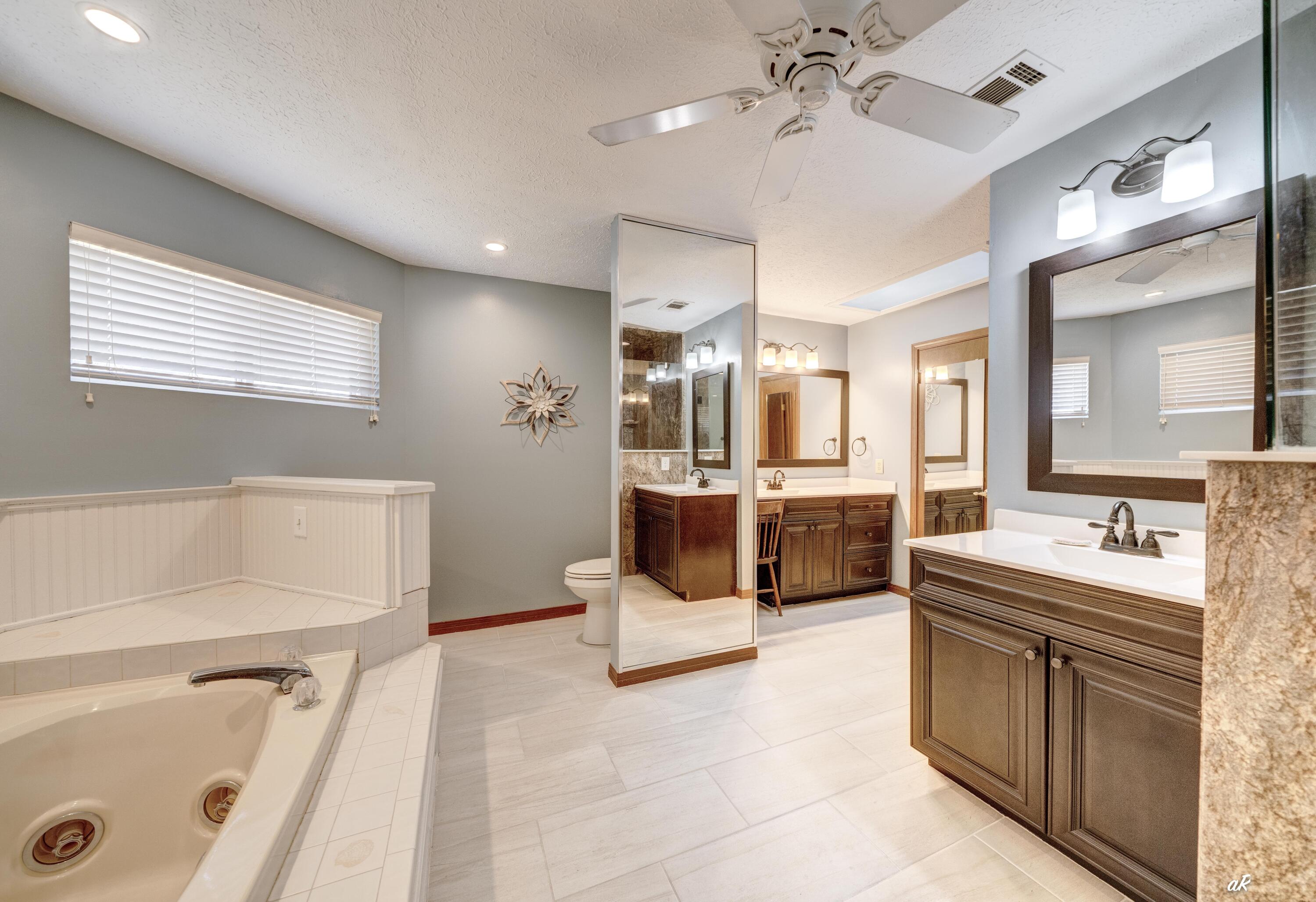 2910 Kings Harbour Road Panama City, FL 32405 - Photo 29 of 50 a large white bathroom with a double vanity sink a mirror and a bathtub