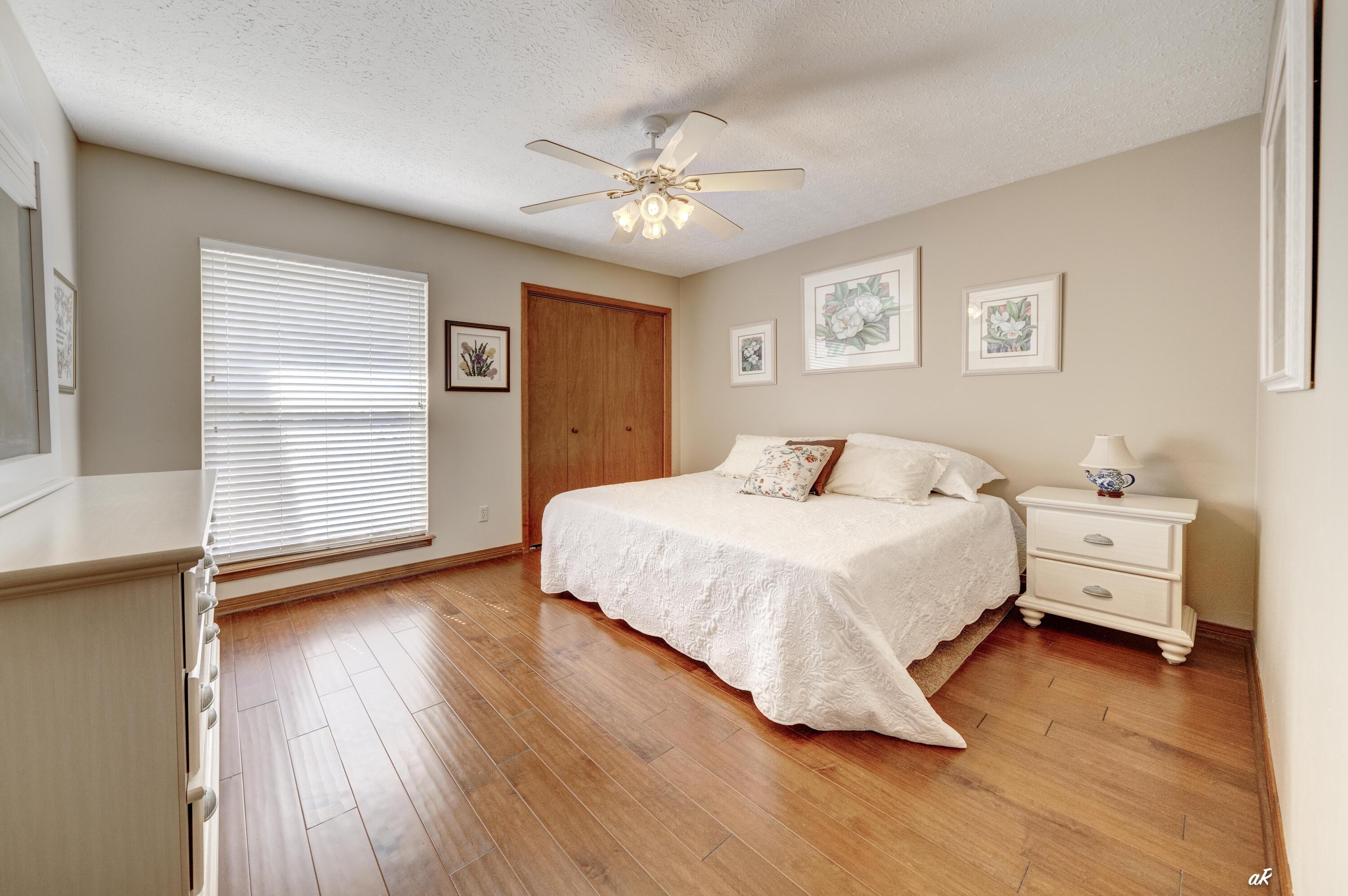 2910 Kings Harbour Road Panama City, FL 32405 - Photo 30 of 50 a bedroom with a bed and wooden floor