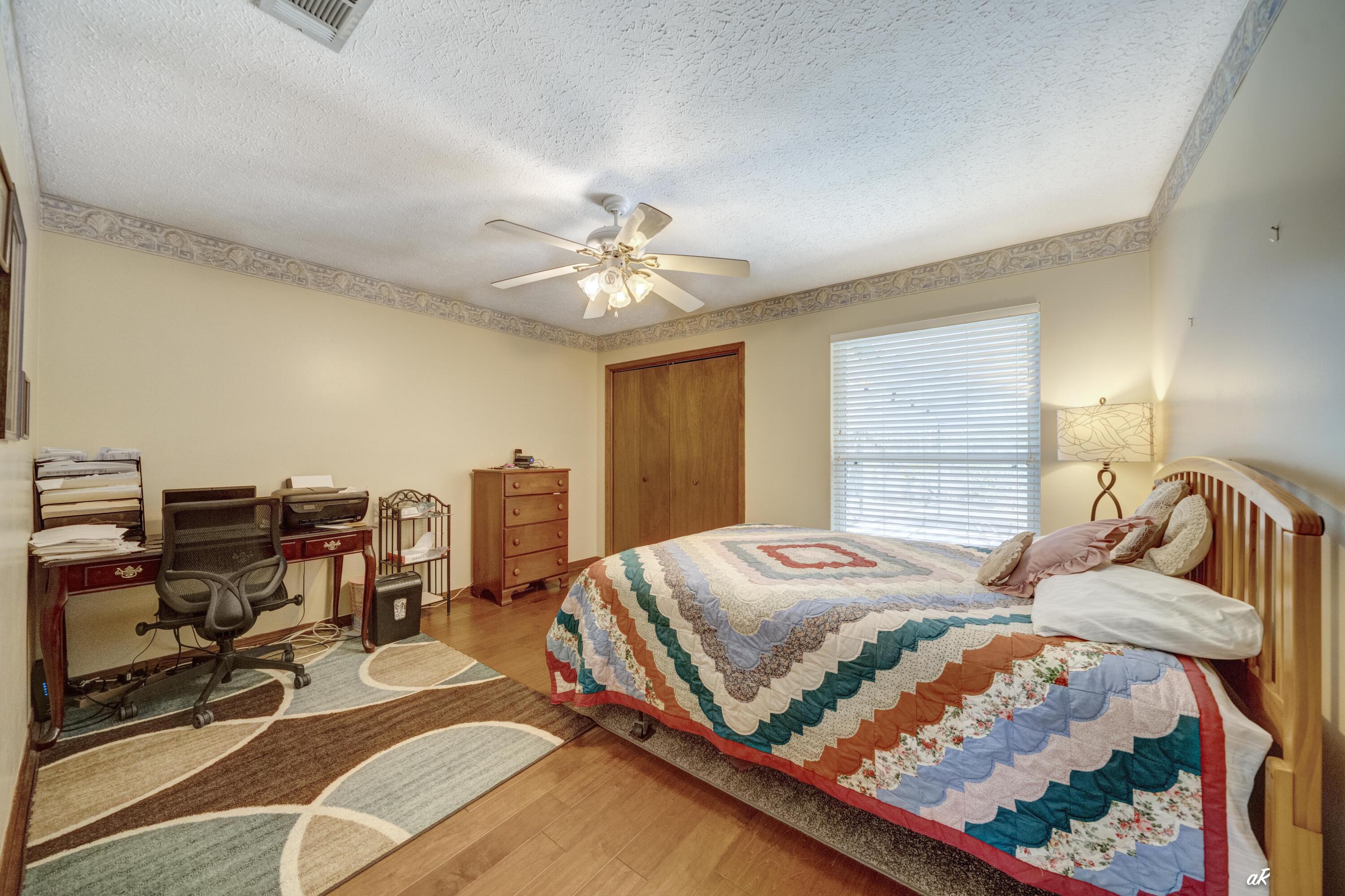 2910 Kings Harbour Road Panama City, FL 32405 - Photo 31 of 50 a bedroom with a bed gym equipment and a large window