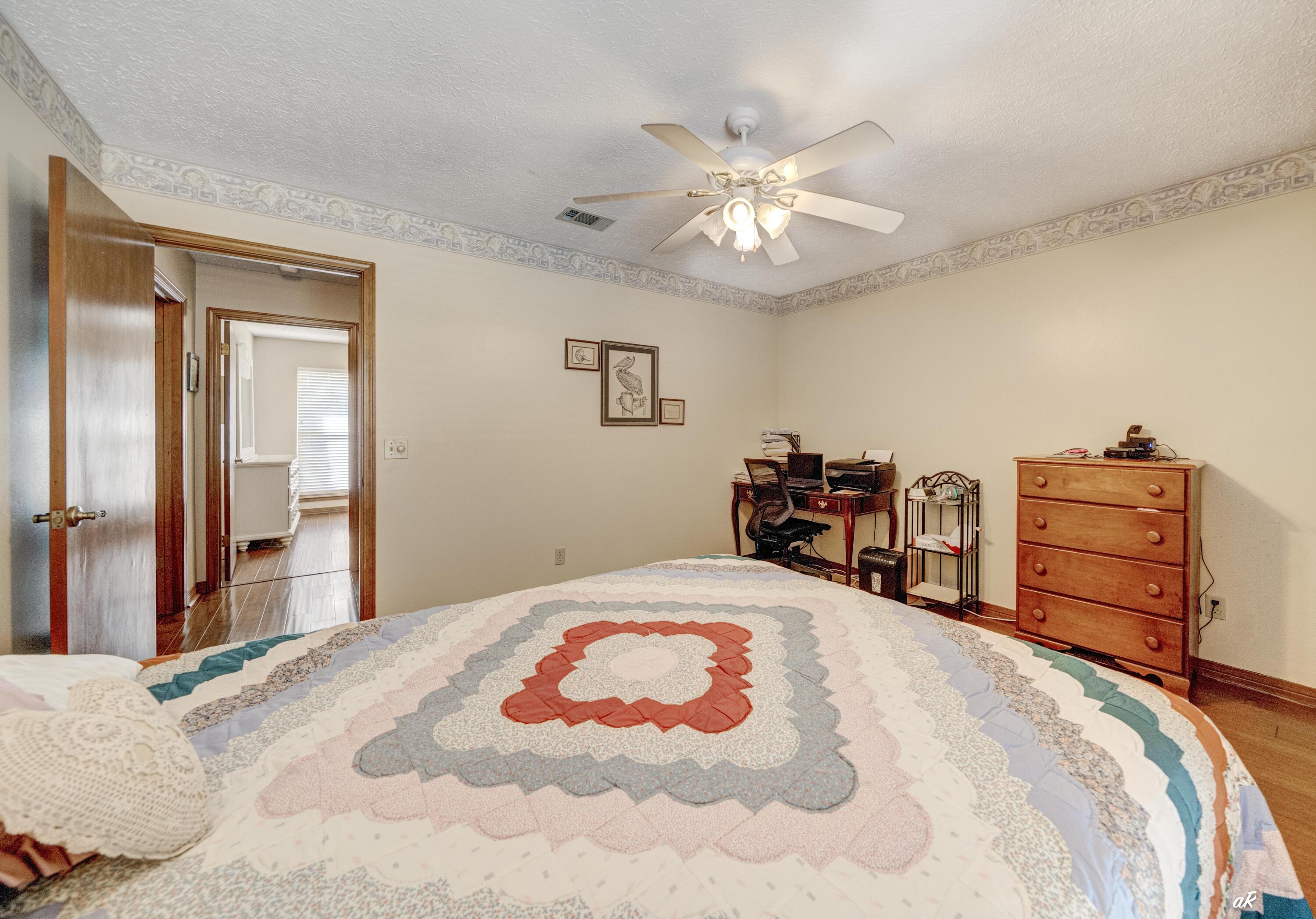 2910 Kings Harbour Road Panama City, FL 32405 - Photo 32 of 50 a bedroom with a bed and dresser