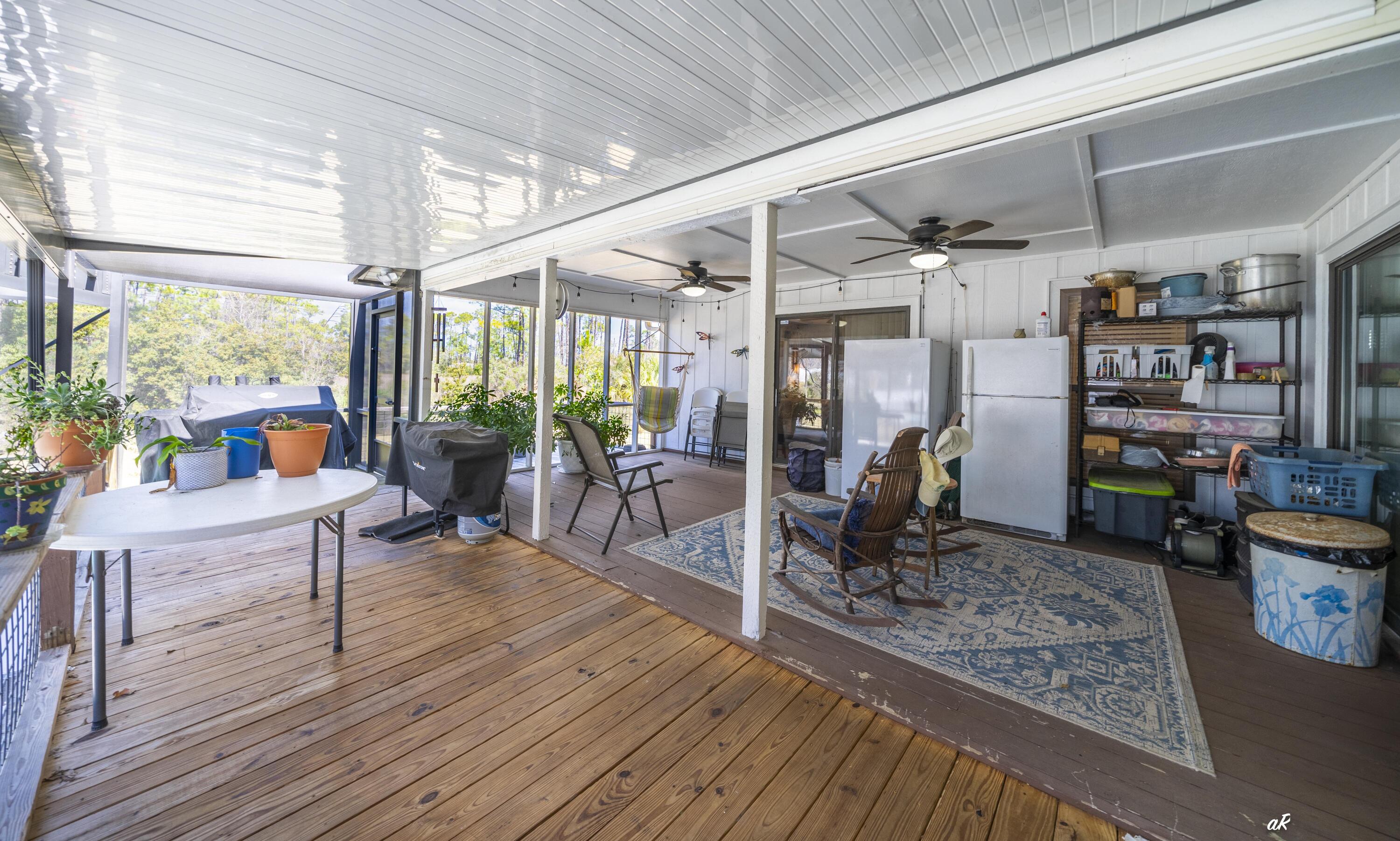 2910 Kings Harbour Road Panama City, FL 32405 - Photo 37 of 50 a living room filled with furniture and a book shelf