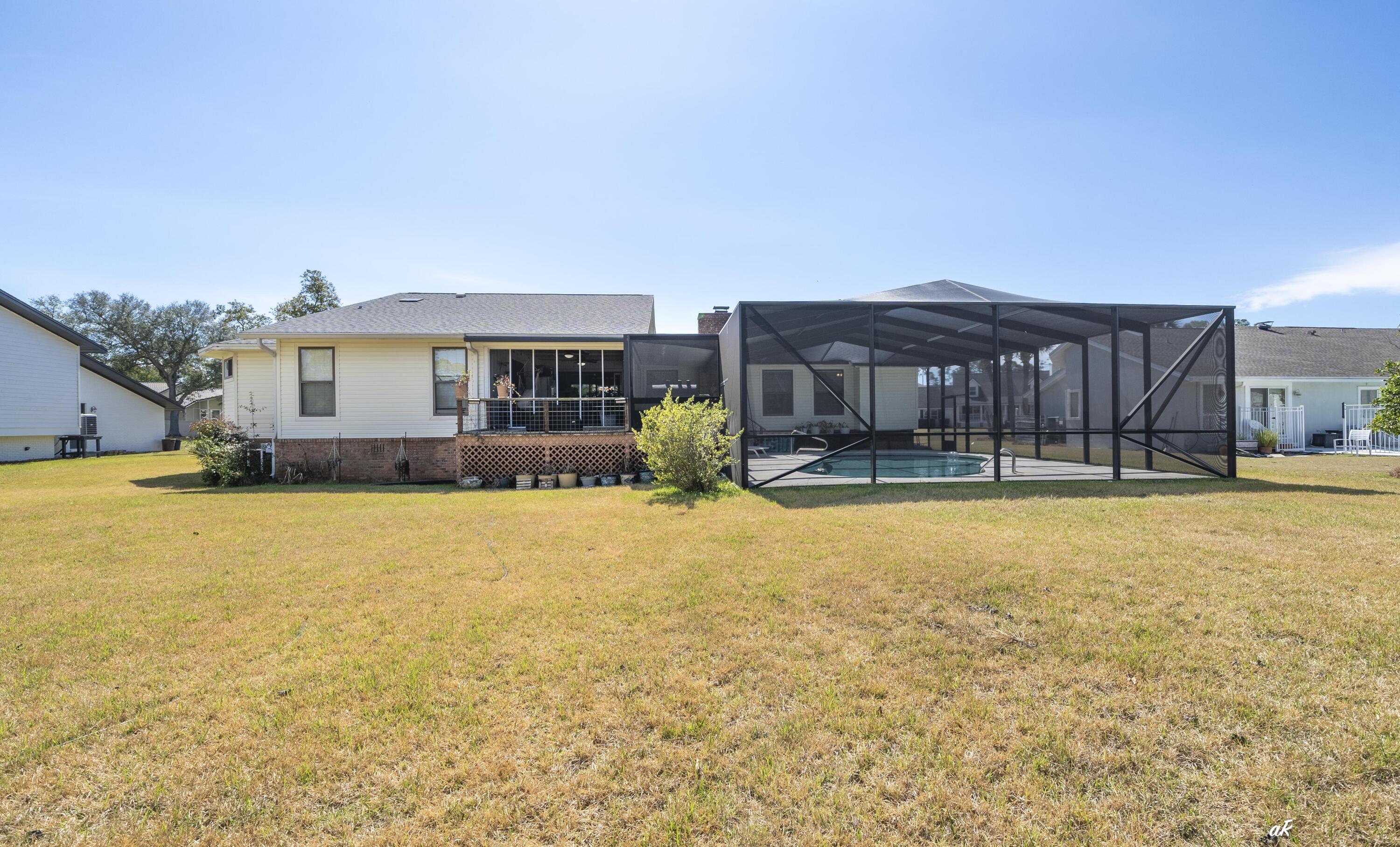 2910 Kings Harbour Road Panama City, FL 32405 - Photo 39 of 50 a view of swimming pool with large trees and wooden fence
