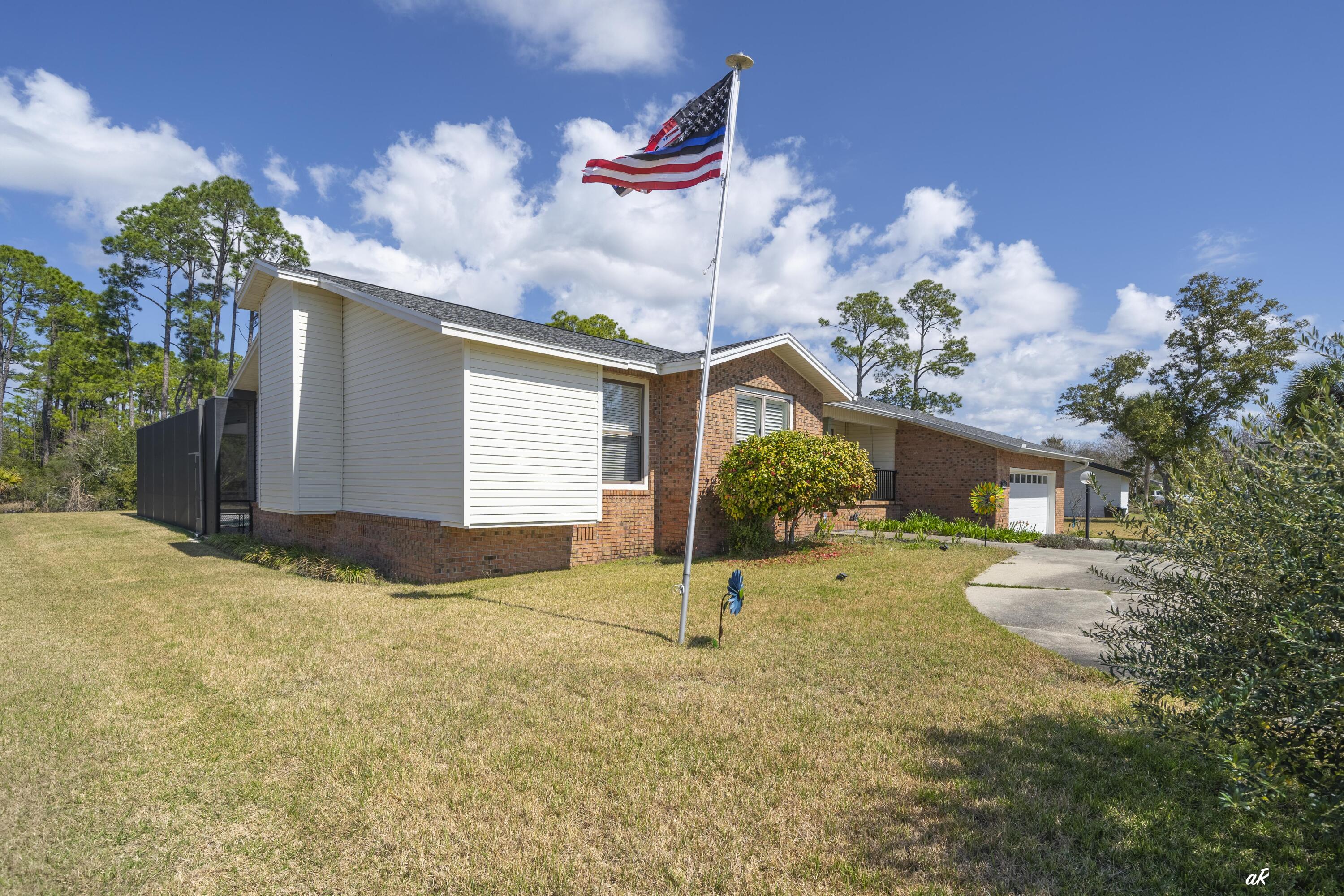 2910 Kings Harbour Road Panama City, FL 32405 - Photo 40 of 50 a view of a house with a yard and garage