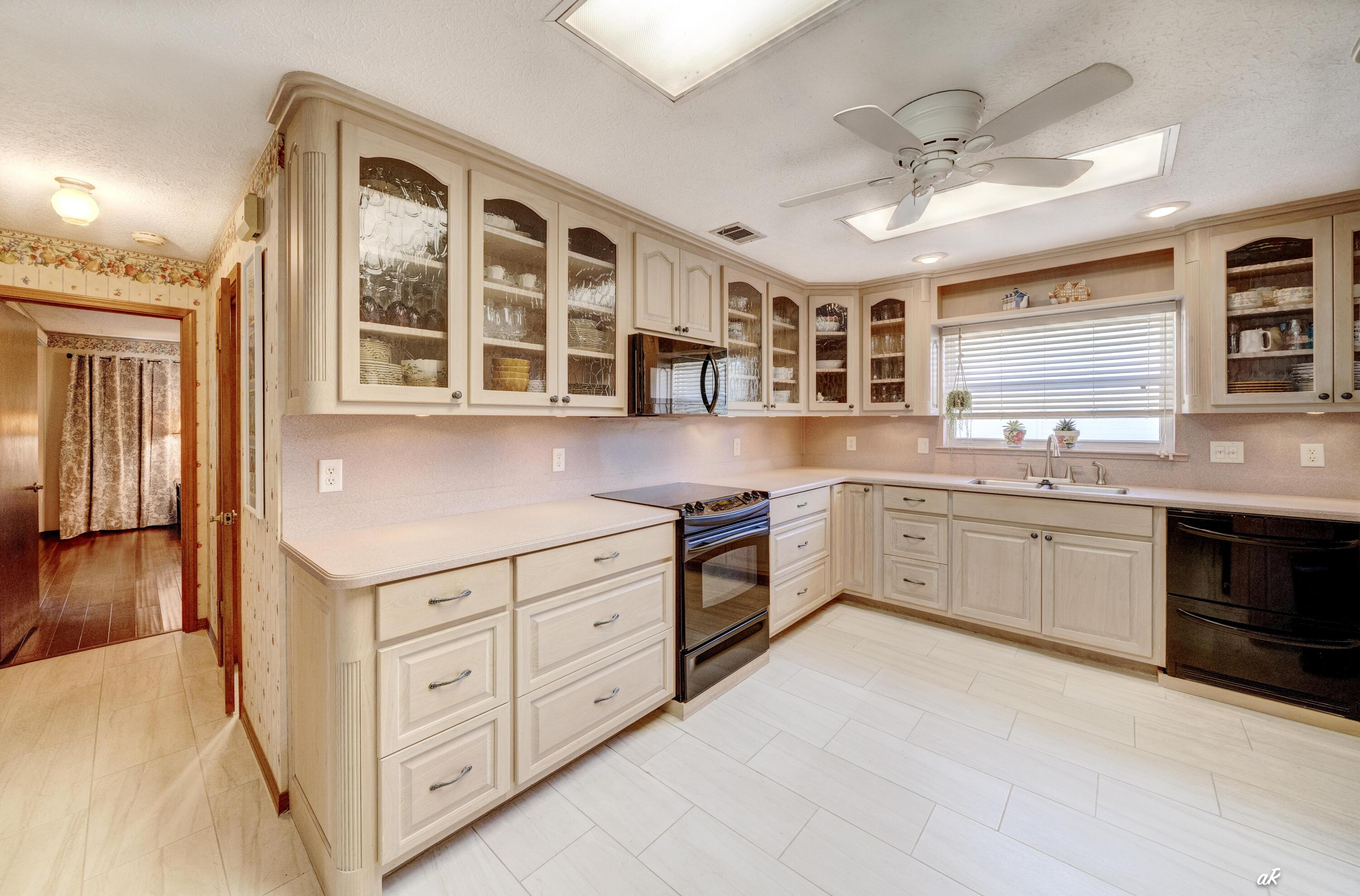 2910 Kings Harbour Road Panama City, FL 32405 - Photo 10 of 50 a kitchen with stainless steel appliances granite countertop a stove and cabinets