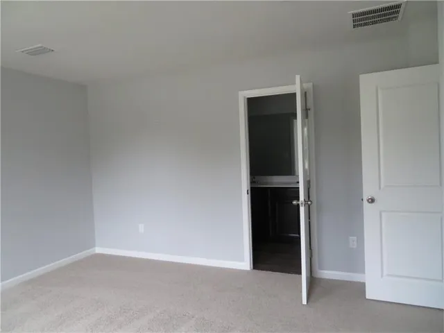 a view of an empty room with closet