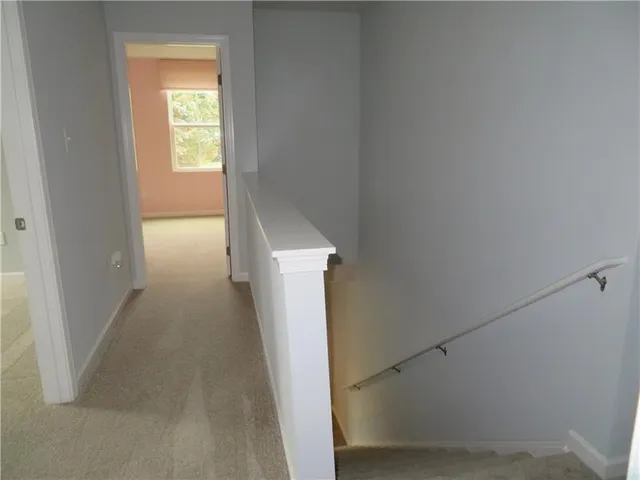 a view of a hallway with wooden floor and a hallway