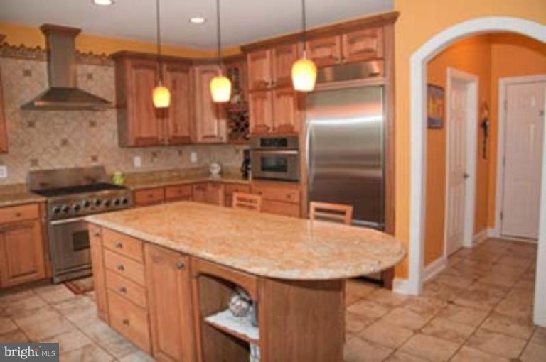 14616 Manor Road Phoenix, MD 21131 - Photo 11 of 30 a kitchen with stainless steel appliances granite countertop a sink a stove and a refrigerator